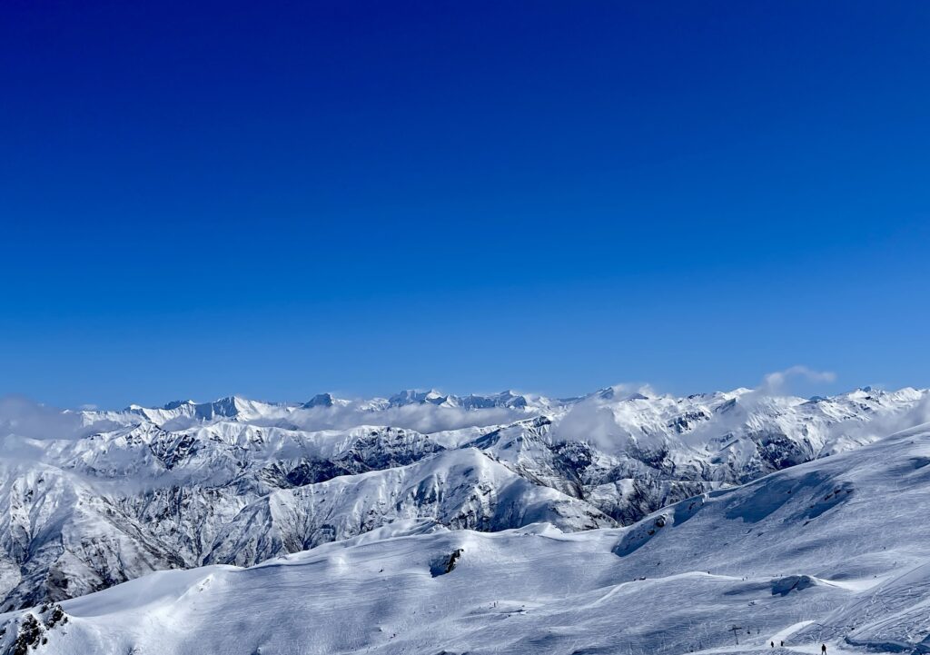 Snow-covered mountains beneath a brilliant blue sky in New Zealand's Southern Alps